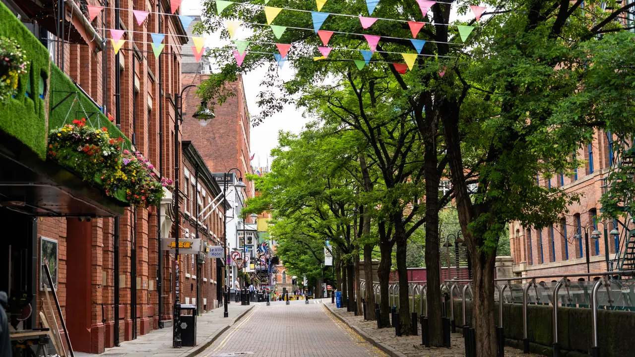 Canal Street in Manchester city centre, lined with red-brick buildings