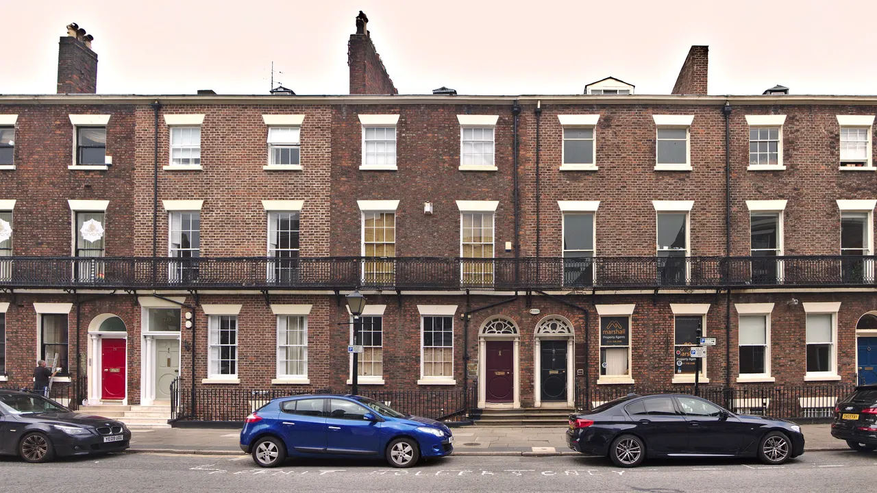 Georgian red-brick terrace with black railings and balconies on Rodney Street, Liverpool